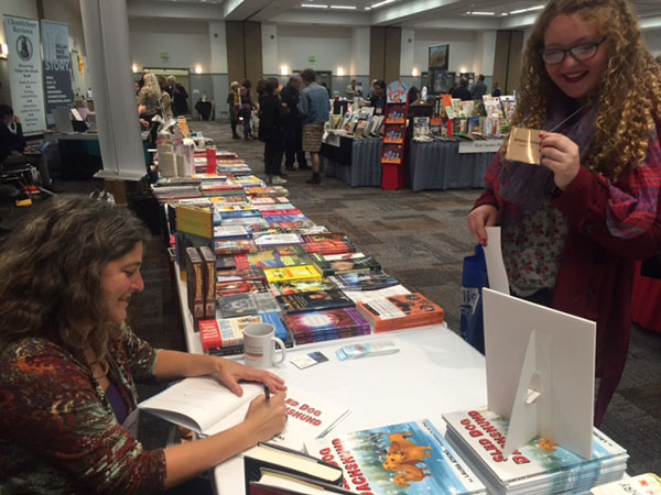 Laura Atkins signing Sled Dog Dachshund book